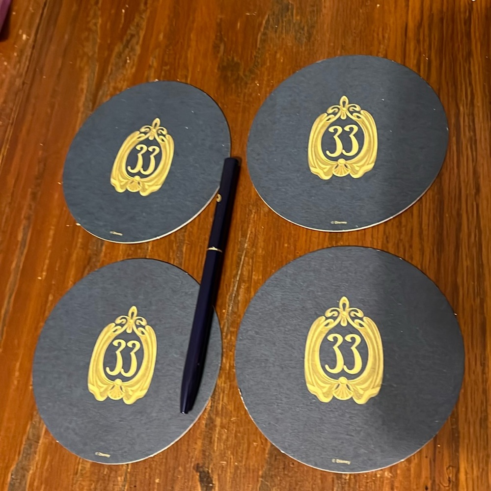 Club 33 paper coasters blue and gold logo w/ pen.